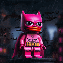 a pink lego batman with a yellow beak is standing in the rain