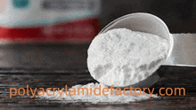 a spoon filled with white powder is on a table .