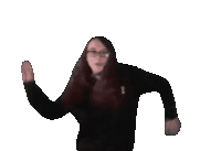 a woman wearing glasses and a black sweater is dancing in front of a white background