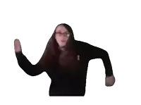 a woman wearing glasses and a black sweater is dancing in front of a white background