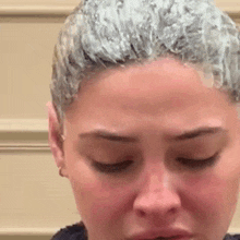 a close up of a woman 's face with a lot of hair dye on it .