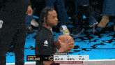 darius garland is holding a basketball during a basketball game