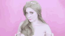 a woman is wearing a tiara and a princess costume .