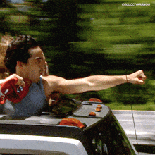 a man driving a car with the name colucciyarango on the bottom right