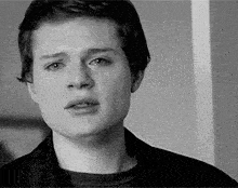 a young man with a serious look on his face