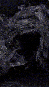 the letter z is glowing in a puddle of water