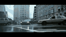 a car is driving down a wet street in the city