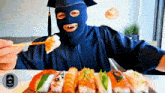 a man wearing a ski mask is eating sushi with chopsticks