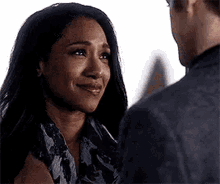 a man and a woman are looking at each other . the woman is crying and the man is smiling .