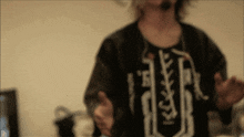 a blurry photo of a person wearing a shirt that says ' r ' on it