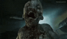 a close up of a zombie with its mouth open at the summer gamefest
