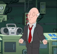 a bald man in a suit and tie stands in front of a boombox