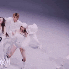 a group of people are dancing in front of a sign that says com on it