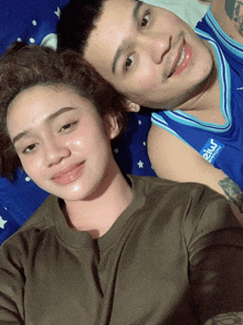a man and a woman are posing for a picture and the man is wearing a shirt that says beko sports on the front