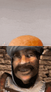 a close up of a man 's face with a bread on his head