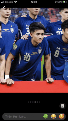 a group of soccer players are posing for a photo and one of them has the number 10 on his shirt