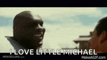 a man is talking to another man with the words `` i love little michael '' .