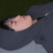 a person is laying on their back with their eyes closed and a fork in their mouth .