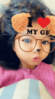 a little girl wearing glasses and a mask that says i love my gf on her face