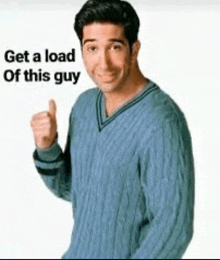 a man wearing a blue sweater is giving a thumbs up .