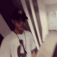 a blurry picture of a man wearing a hat and sunglasses
