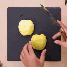 two apples are being peeled on a cutting board