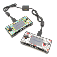 two game boy controllers are connected to each other with a cord
