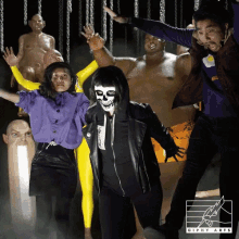 a group of people are dancing in front of a sign that says giphy arts on it