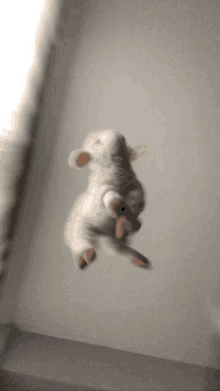 a stuffed animal is flying through the air in a blurry photo