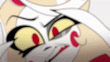 a close up of a cartoon character 's face with yellow eyes and red dots .