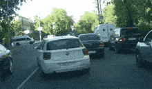 a white car with a license plate that says 56-no1-59 is driving down a street