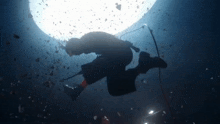 a man is singing into a microphone while swimming in the ocean