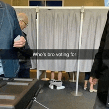a man sitting in a voting booth with the words who 's bro voting for on the bottom