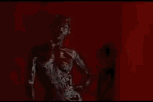 a robot is standing in front of a red curtain with a red cube in the background .
