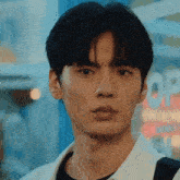 a close up of a young man 's face with a blurred background .