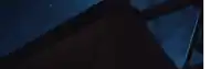 a blurry picture of a person standing in the dark with a light behind them