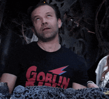 a man wearing a shirt that says goblin king