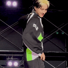 a person wearing a black and green jacket with a skull and crossbones on the back