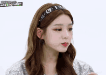 a close up of a woman wearing a headband