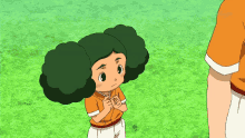 a cartoon character with green hair is standing in the grass next to a man in an orange shirt that says tokyo