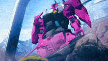 a pink robot with the letter g on its chest