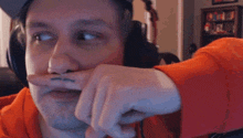 a man wearing headphones has a tattoo on his finger that says ' i love you '