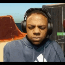 a young man wearing headphones is making a funny face .
