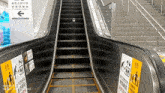 an escalator with a sign that says " please do not enter if you are hungry "