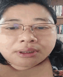 a close up of a woman 's face with glasses on