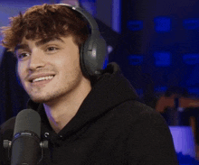 a man wearing headphones and a shure microphone