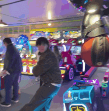 a blurry picture of people in an arcade with a sign that says ' a ' on it