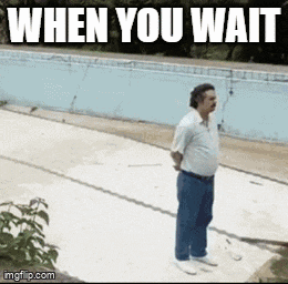 a man is standing in front of a swimming pool with the words when you wait written above him