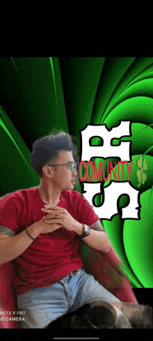 a man in a red shirt is sitting in front of a green background with the word community written on it