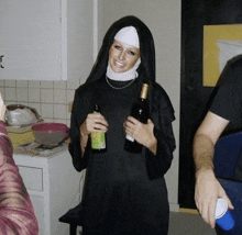 a woman dressed as a nun is holding a bottle of beer